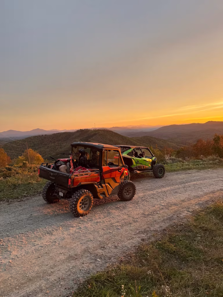Two UTVs at sunset on a mountain ridge road in the Smokies