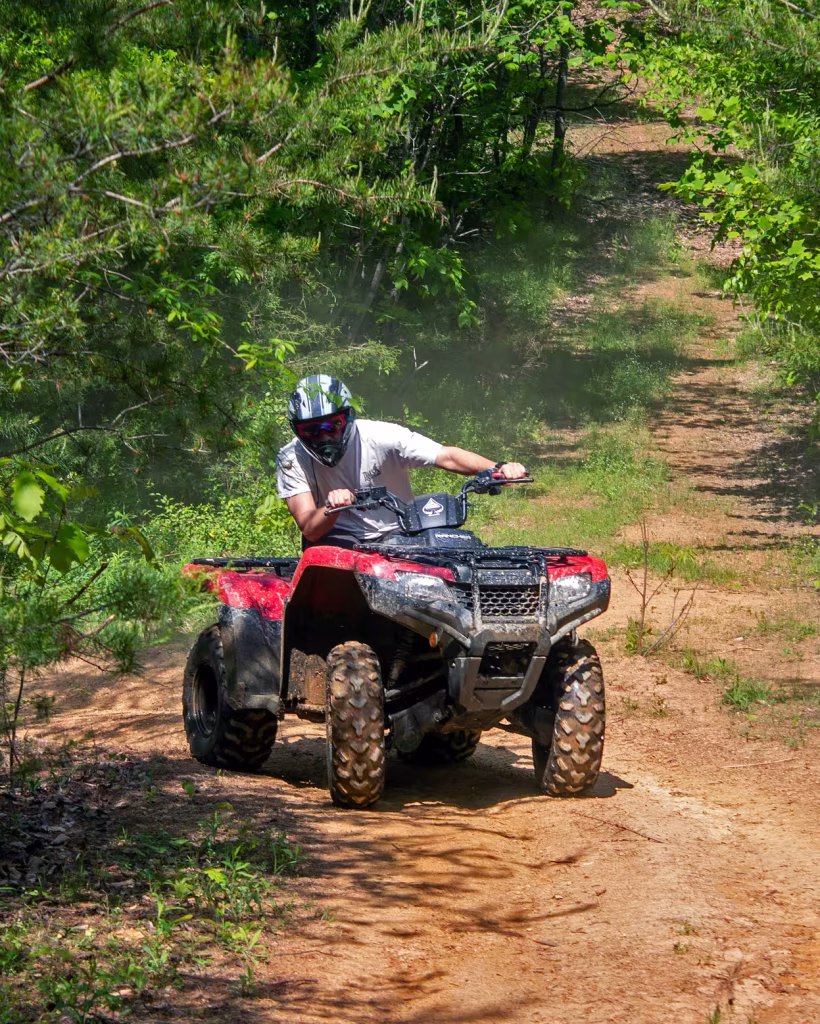 Rider on a red ATV during a guided off-road tour in the Smoky Mountains